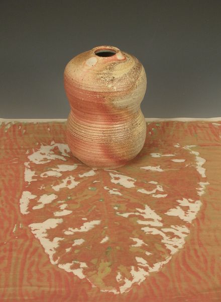 Body of ceramic works shown with companion textiles